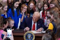 President Donald Trump signs an executive order barring transgender female athletes from compet ...