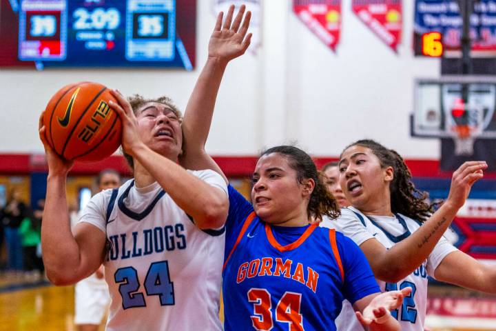 Centennial forward Nation Williams (24) takes an elbow under the basket by Bishop Gorman guard ...