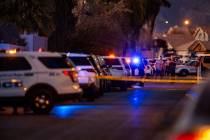 Personnel work the scene of a North Las Vegas Police officer-involved shooting along the 4700 b ...