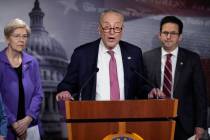 Senate Minority Leader Chuck Schumer, D-N.Y., center, flanked by Sen. Elizabeth Warren, D-Mass. ...