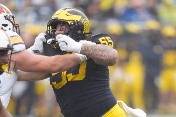 Michigan defensive lineman Mason Graham (55) plays during the first half of an NCAA college foo ...