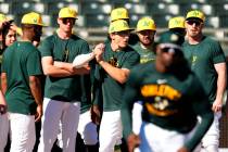 Athletics players run drills during a spring training baseball workout, Friday, Feb. 21, 2025, ...