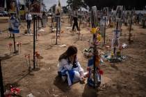 FILE - A woman grieves at a memorial for those killed and abducted during the Oct. 7, 2023, cro ...