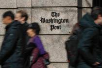 FILE - People walk by the One Franklin Square Building, home of The Washington Post newspaper, ...