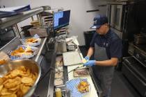 Jose Aleman cooks in the kitchen at Saginaw’s Deli at Circa hotel-casino in Las Vegas, Thursd ...