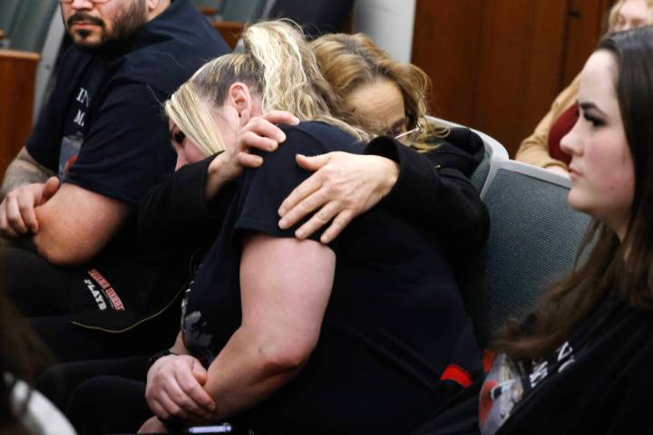 Friends and family members of a shooting victim Jonathan Getz comfort each other as they attend ...