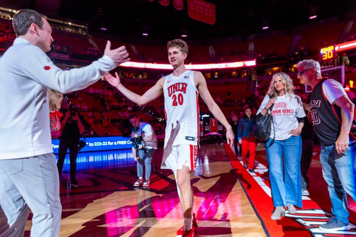 UNLV head coach Kevin Kruger greets guard Julian Rishwain (20) and his family on senior night b ...