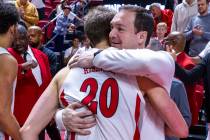 UNLV head coach Kevin Kruger hugs UNLV guard Julian Rishwain (20) after a big night against the ...