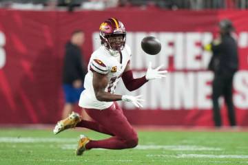 Washington Commanders safety Jeremy Chinn (11) eyes an incoming pass during an NFL football Wil ...