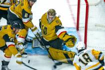 Golden Knights goaltender Ilya Samsonov (35) and teammates defend the net with a shot by Pittsb ...