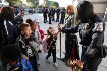 North Las Vegas Chief of Police Jacqueline Gravatt greets kindergartner Abigail Ramirez durin ...