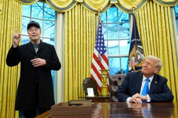 President Donald Trump listens as Elon Musk speaks in the Oval Office at the White House, Tuesd ...